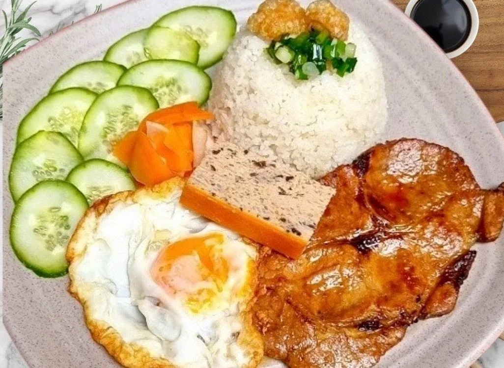 Cơm tấm grilled pork rice with fried egg, cucumber and pickled carrot